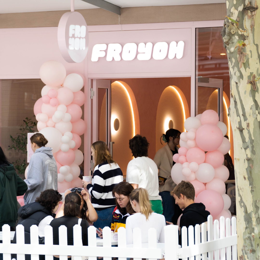 The pink Fro Yoh storefront in North Adelaide with balloon garlands and customers out front