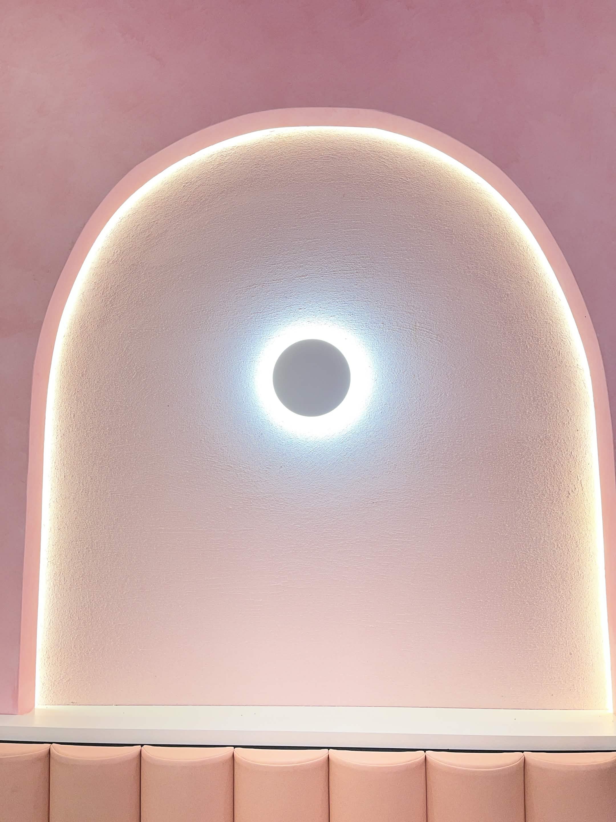 Close-up of a glowing arched wall niche inside Fro Yoh